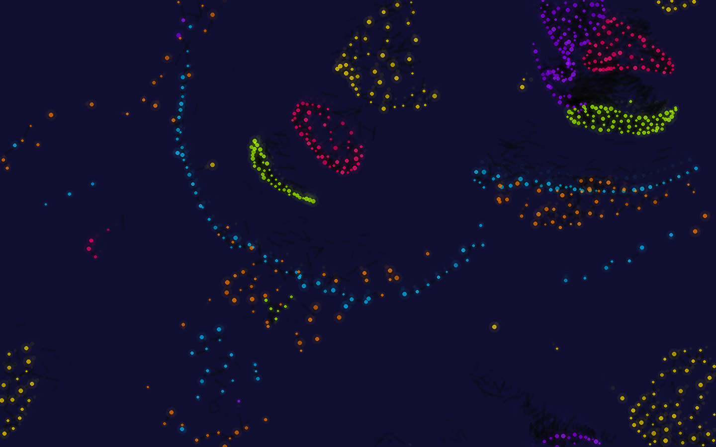 Particle Life: clusters of colored particles over a deep navy background